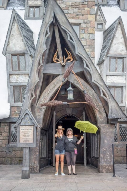 Sisters outside of The Three Broomsticks Visiting Harry Potter World Orlando